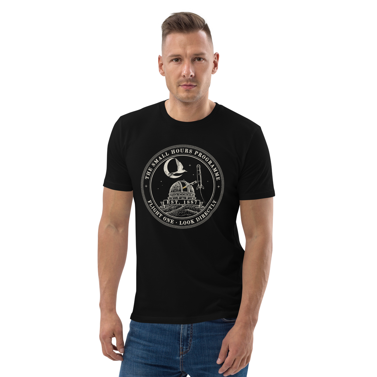 Model wearing the Small Hours Programme, Flight One tee in Black, the round stitched patch at centre chest