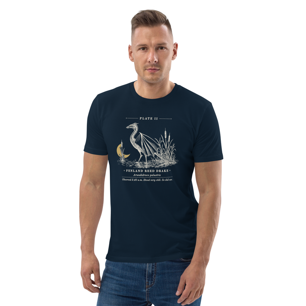 Model wearing the Fenland Reed Drake tee in French Navy, engraved winged reed drake wading in the reeds at centre chest