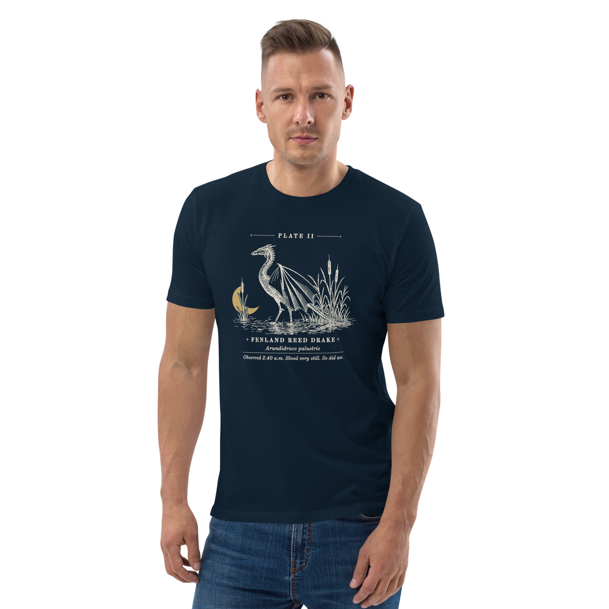 Model wearing the Fenland Reed Drake tee in French Navy, engraved winged reed drake wading in the reeds at centre chest