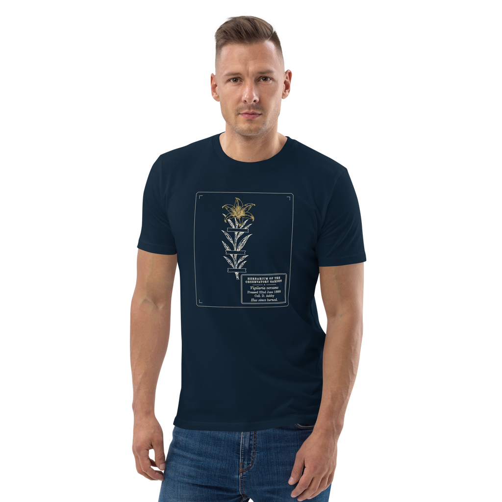 Model wearing the Pressed, Still Turning tee in French Navy, the pressed flower and gold flower head at centre chest