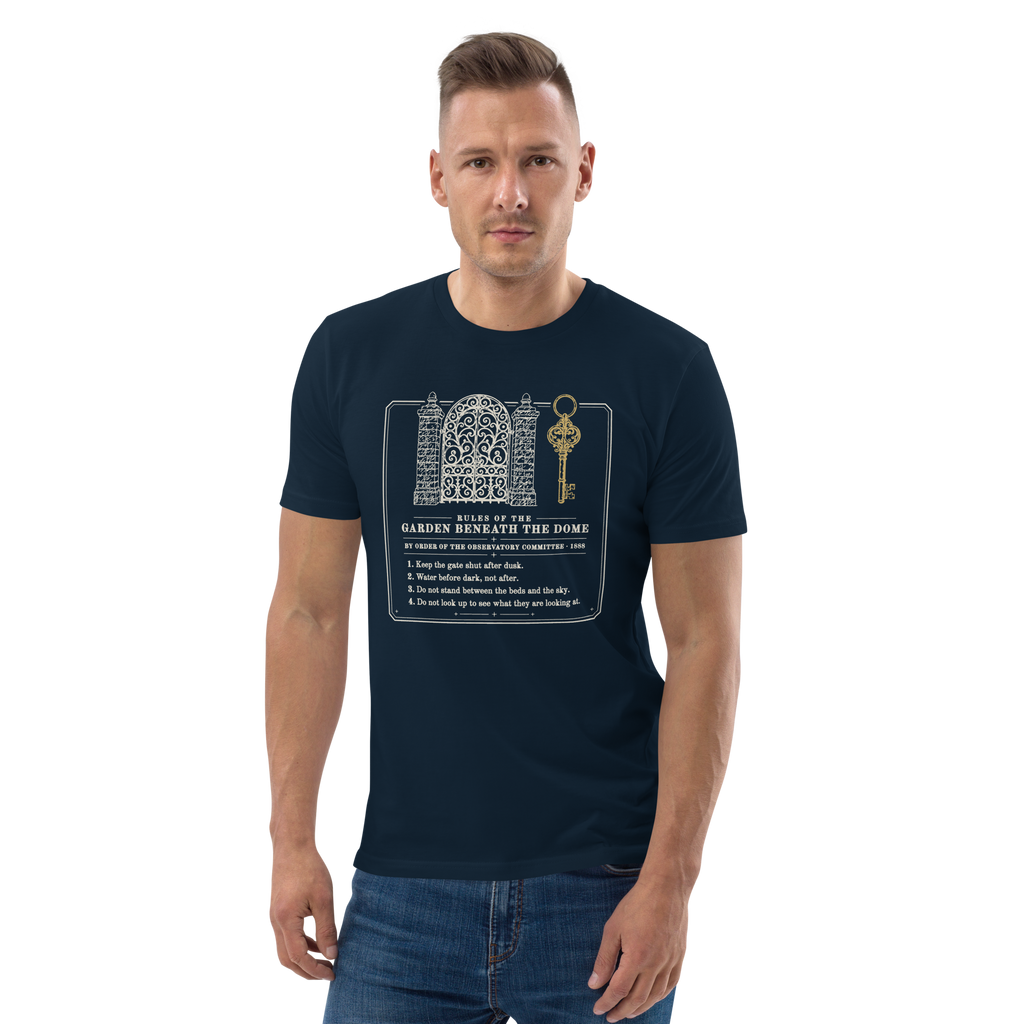 Model wearing the Rules of the Garden Beneath the Dome tee in French Navy, the gate, gold key and four rules at centre chest