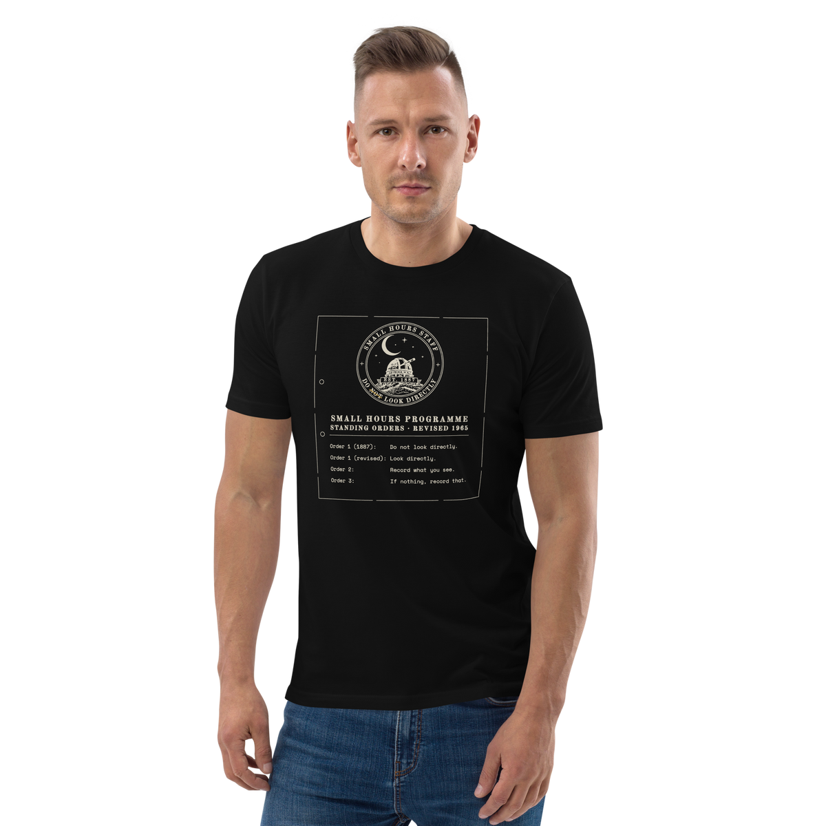 Model wearing the Standing Orders, Revised tee in Black, the typed memo and crest at centre chest