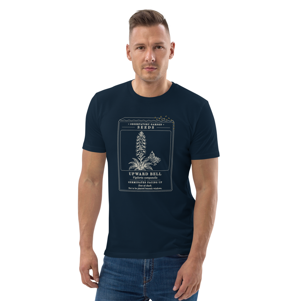 Model wearing the Germinates Facing Up tee in French Navy, the seed packet and gold seeds at centre chest