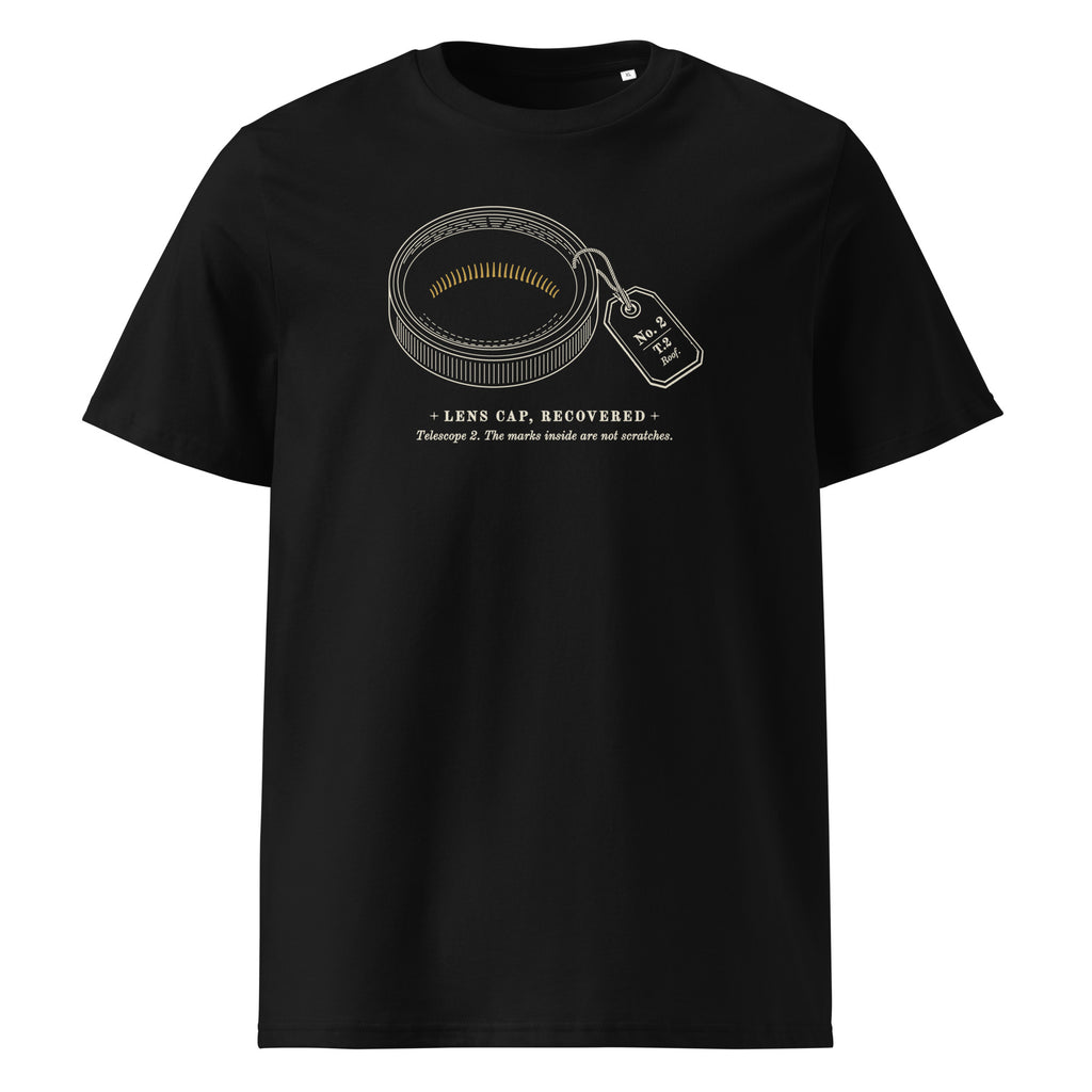 Lens Cap, Recovered t-shirt in Black: engraved brass lens cap, inside face up, with fine gold marks and a museum tag